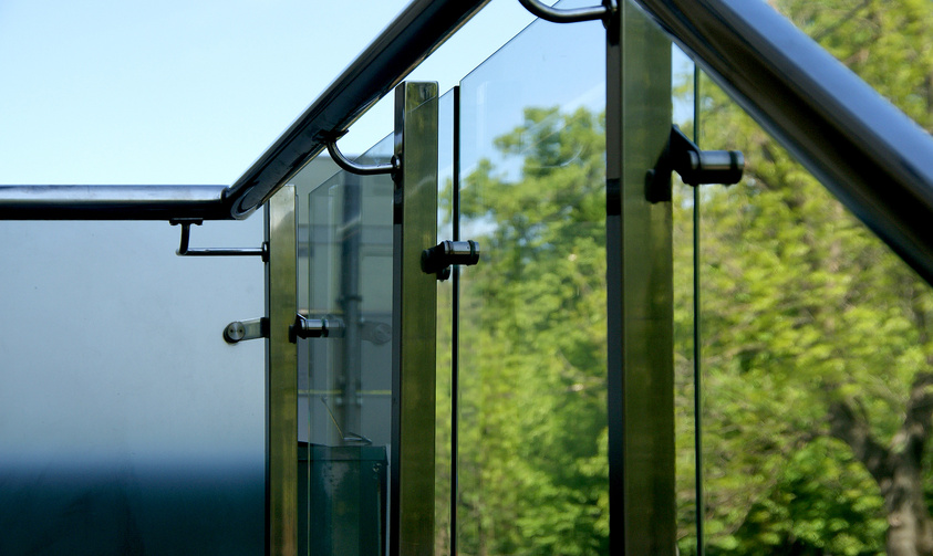 Glass railing at the stairs with handrails